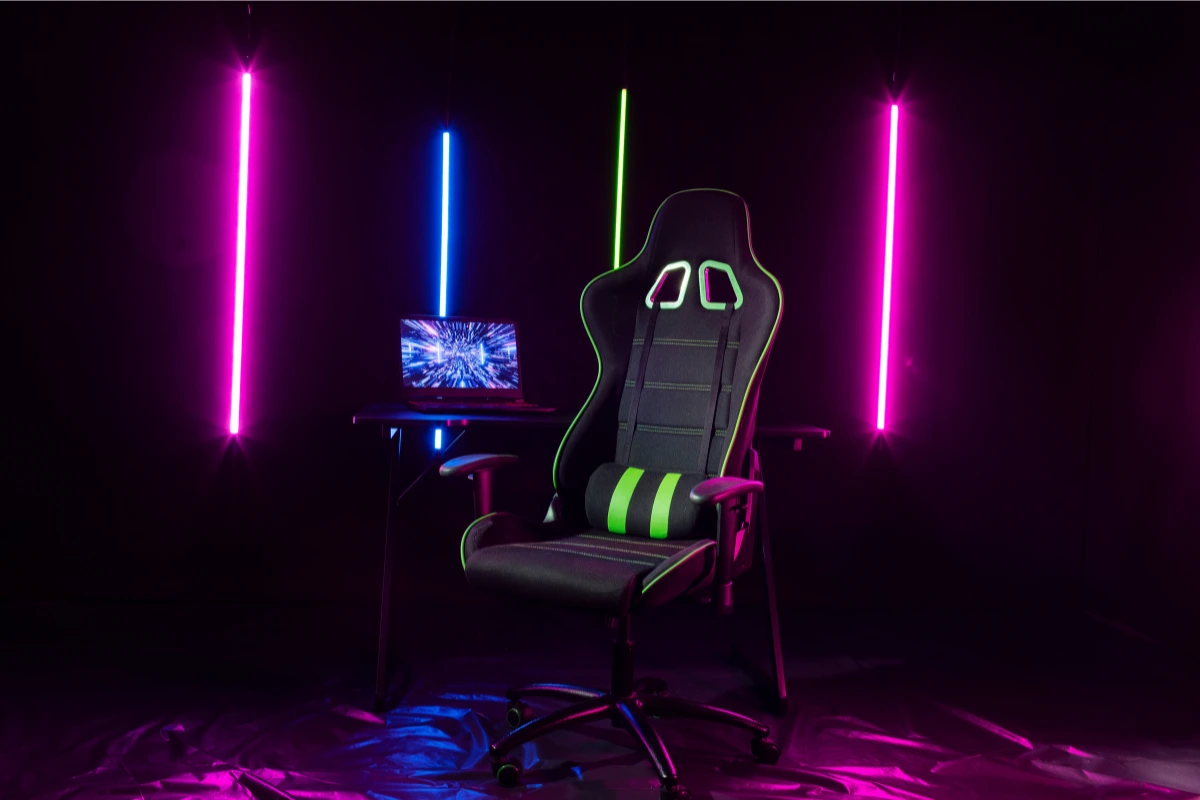 Gaming chair and neon-lit laptop setup in a futuristic dark room