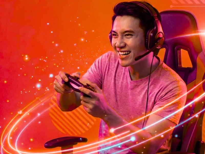 A focused gamer in a headset and gaming chair, surrounded by swirling neon lights and digital effects.