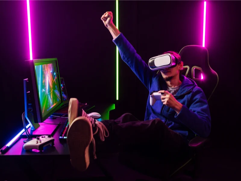 VR gamer raising arm in immersive neon-lit setup